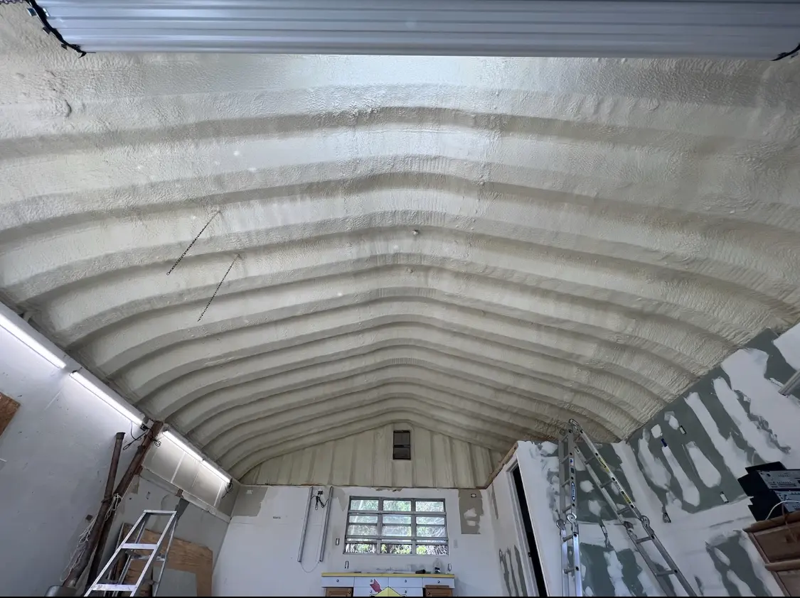 Spray polyurethane foam applied to the underside of a metal roof deck in Orem